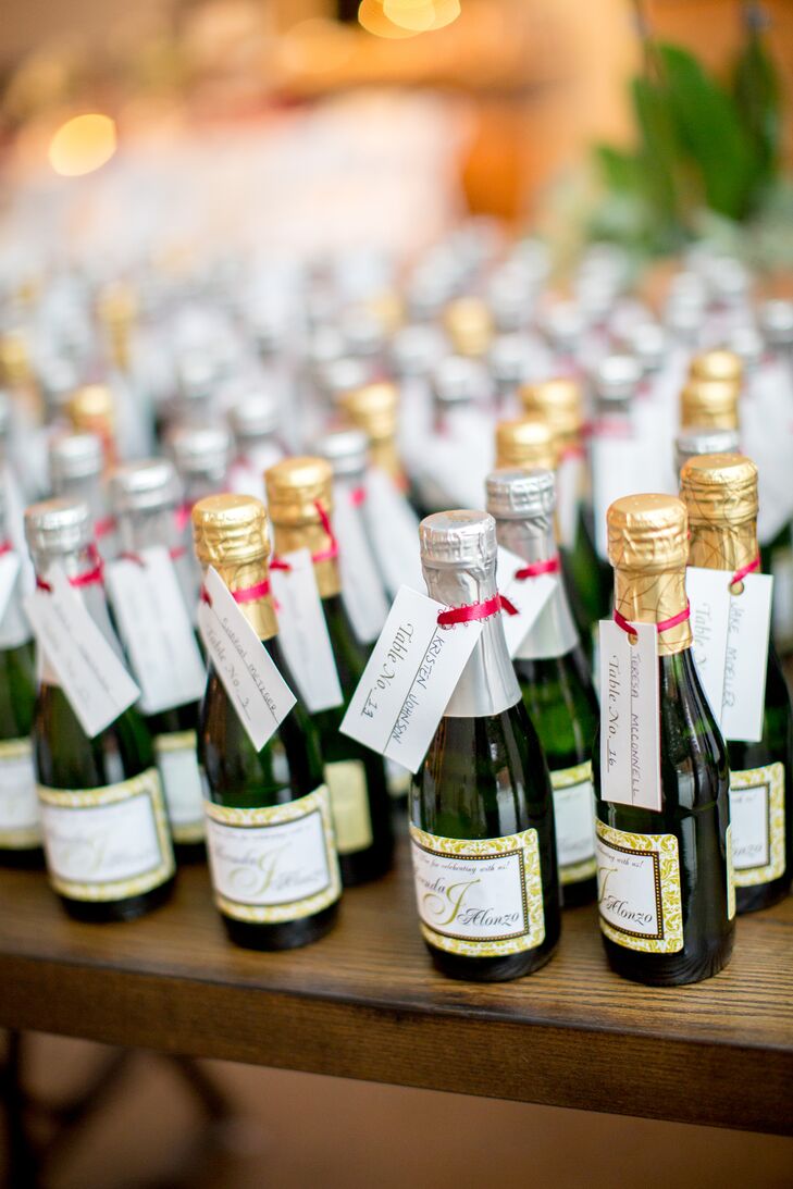 Small bottles of champagne had name tags and table numbers tied to the top. These served as both wedding favors and escort cards.