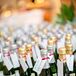 Small bottles of champagne had name tags and table numbers tied to the top. These served as both wedding favors and escort cards.