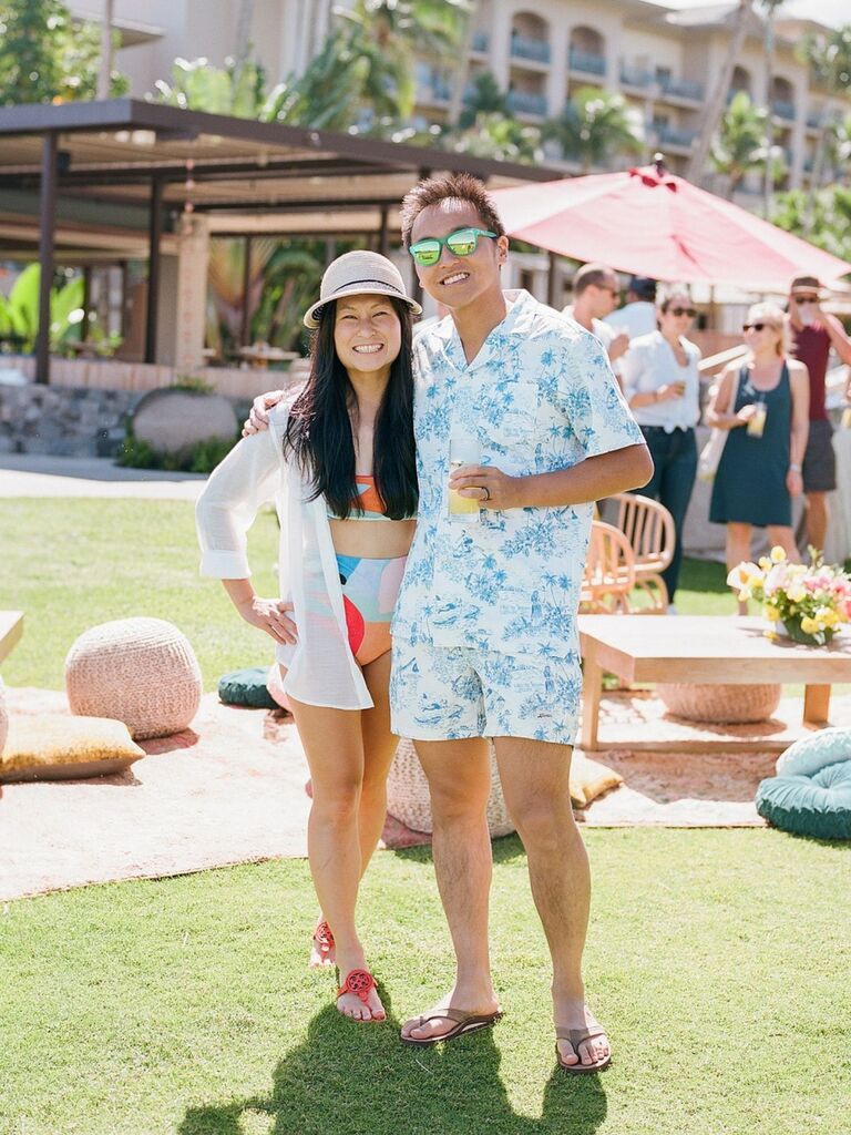 couple dressed in swimsuits at post-wedding pool day