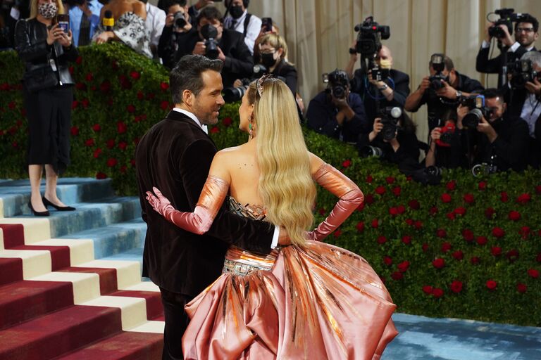 blake lively ryan reynolds on red carpet of the met gala smiling at each other in 2022