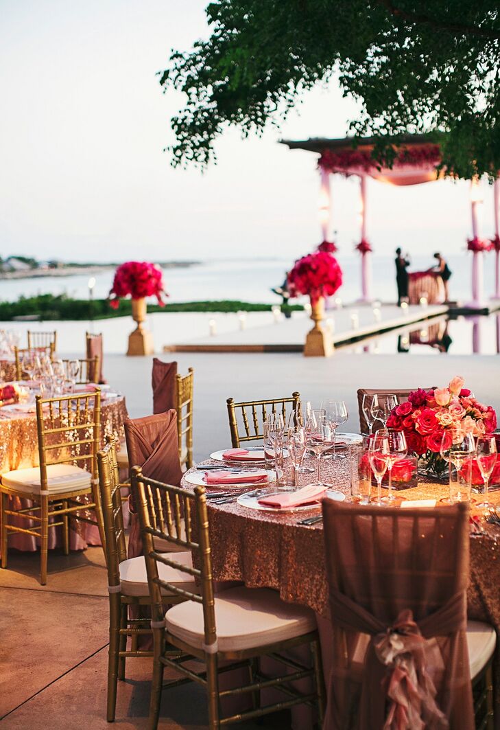 While guests enjoyed cocktail hour, the ceremony space was transformed into a glamorous reception with romantic details like red roses. As the sun set, the infinity pool reflected the starry night, full moon and a fireworks surprise while the couple cut the cake.