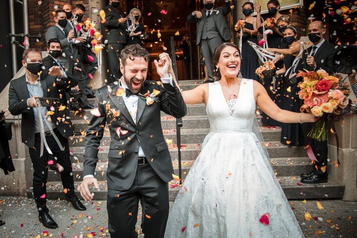 Couple Exiting Church Amid Shower of Flower Petals