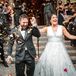 Couple Exiting Church Amid Shower of Flower Petals