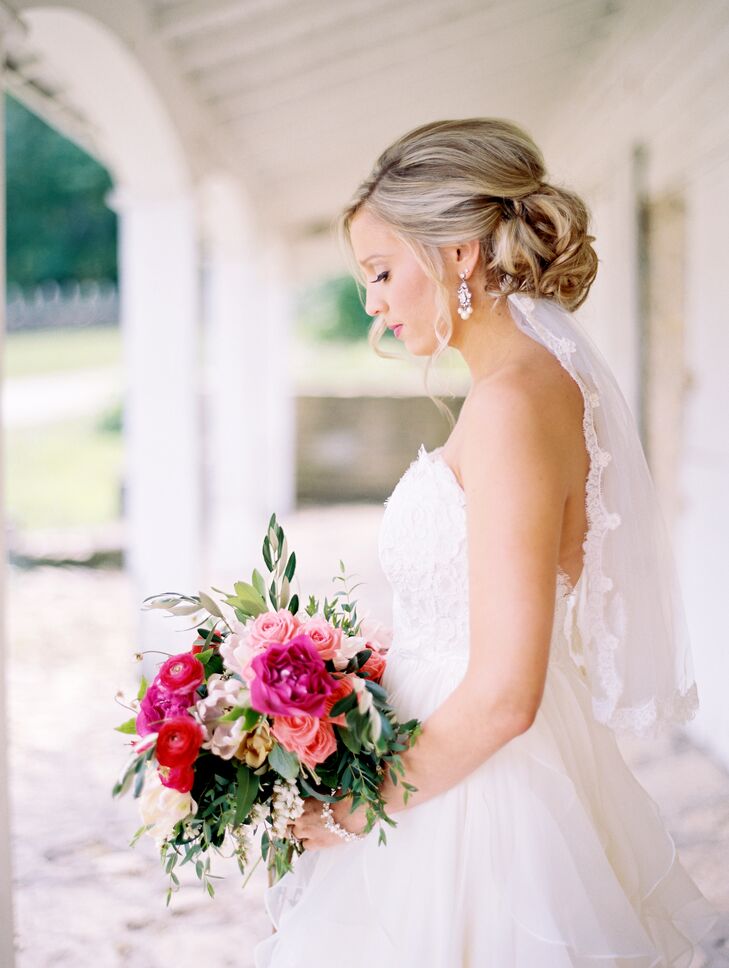 For a classic, romantic look, Kristina wore her hair up in a low, loosely curled updo, adding a lace-trimmed veil for a finishing touch. "When I first started looking for a gown, I tried on my mother’s, which my grandmother made by hand," says Kristina. "It was a beautiful dress, but not quite the style I was going for. Luckily, my grandmother had made a matching headpiece that had a removable veil. I could just pin it right into my hair and the lace detailing matched my gown."