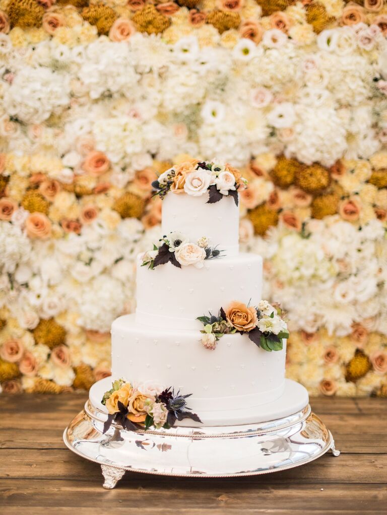 three-tier fall wedding cake decorated with hand-piped polka dots and fresh flowers
