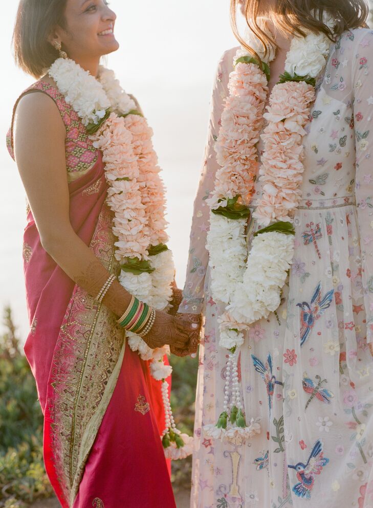 Couple Wearing Indian Marigold Garlands and Holding Hands