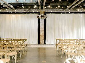 Industrial Loft Ceremony with White Draping, String Lights and Cross-Back Chairs