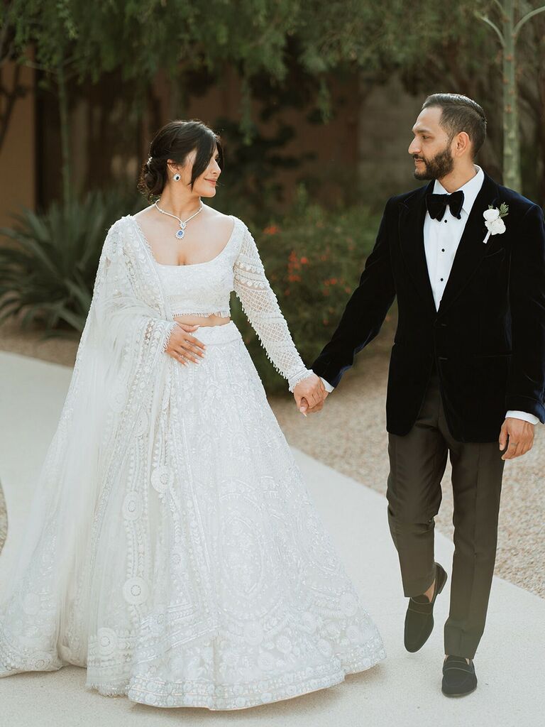 Bride wearing square neck wedding dress with groom 