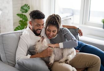 Young couple holding puppy