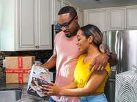 Couple opening weddng registry gifts from The Knot Registry