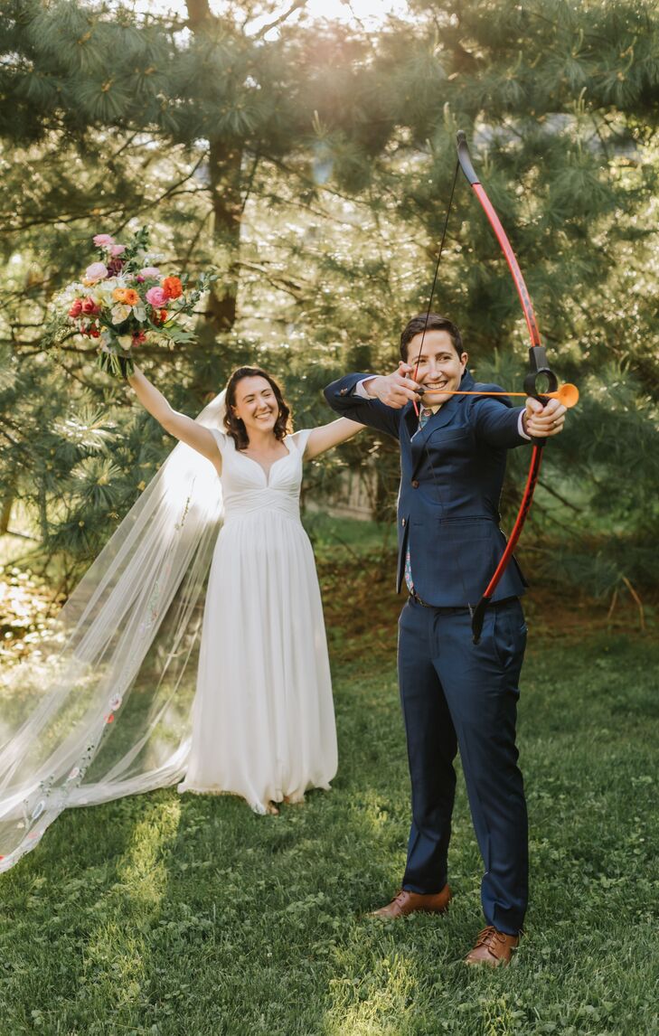 Couple Doing Archery During Camp-Inspired Backyard Wedding