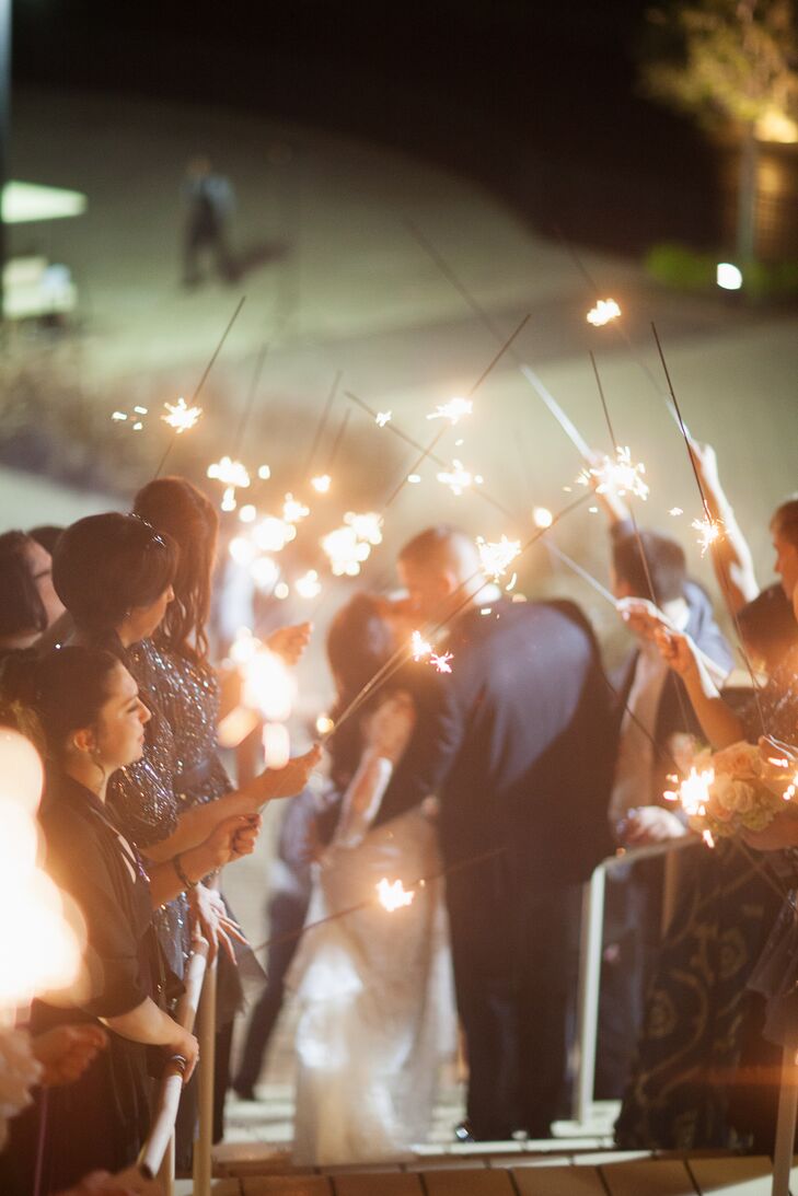 “Since we were all here on the property, but still wanted a grand exit, we got a little creative,” Shayna says. The couple exited down the grand staircase leading to the golf course while guests held four-foot sparklers making a pathway. The couple drove a golf cart around the property before returning to the party.