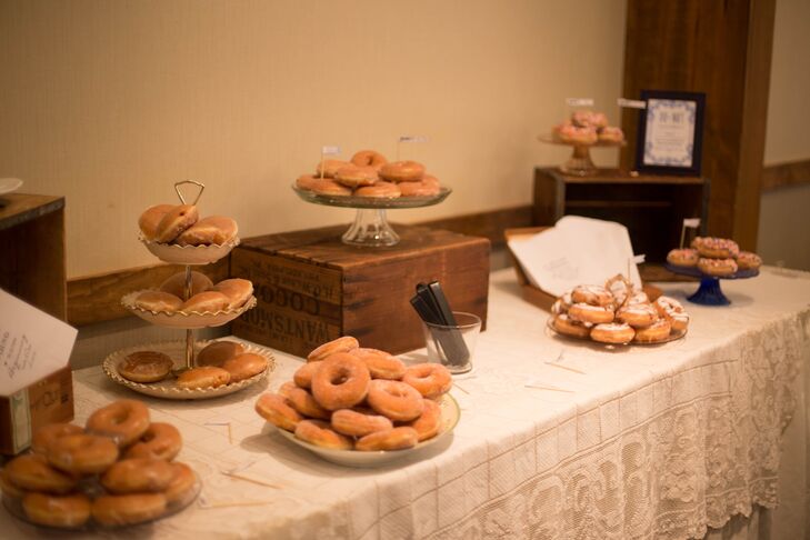 Emily and Chris wanted to bring their new home in North Carolina to the wedding, so they had sweet treats that started in the state: Krispy Kreme doughnuts. Ten types of doughnuts with different fillings, frostings and toppers were stacked on tiers, vintage crates and more from Forget-Me-Knot Vintage Rentals. Guests were invited to munch and take a few home as wedding favors.