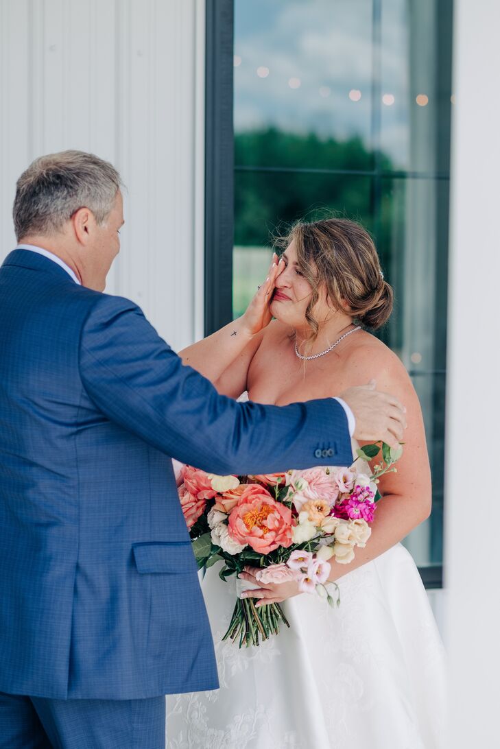 Bride With Colorful Bouquet and Updo Embraces Her Dad in Blue Suit