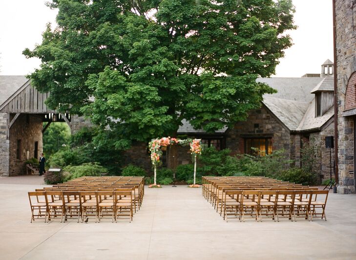 Taking advantage of the barns’ charming stone facades and pristine setting, Alice and Stephen hosted their ceremony outdoors. The couple kept the decor simple so the venue's character could take center stage, adding a birch wedding arch draped in verdant greenery and bright blooms to the end of the aisle to create a focal point for the proceedings.
