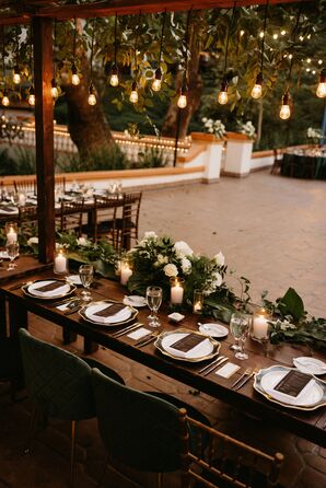 Long Head Table With Hanging Installation of Edison Lights, Hanging Greenery and Floral Runners