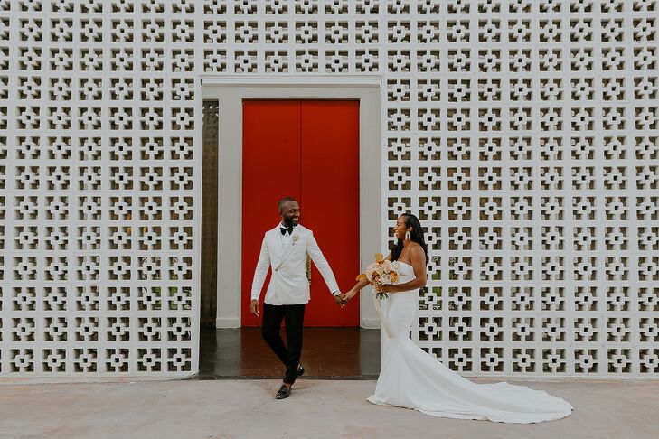 Groom in White Tux Jacket, Black Pants Leads Bride in Sleek Strapless Gown, Mid-Century Modern Backdrop