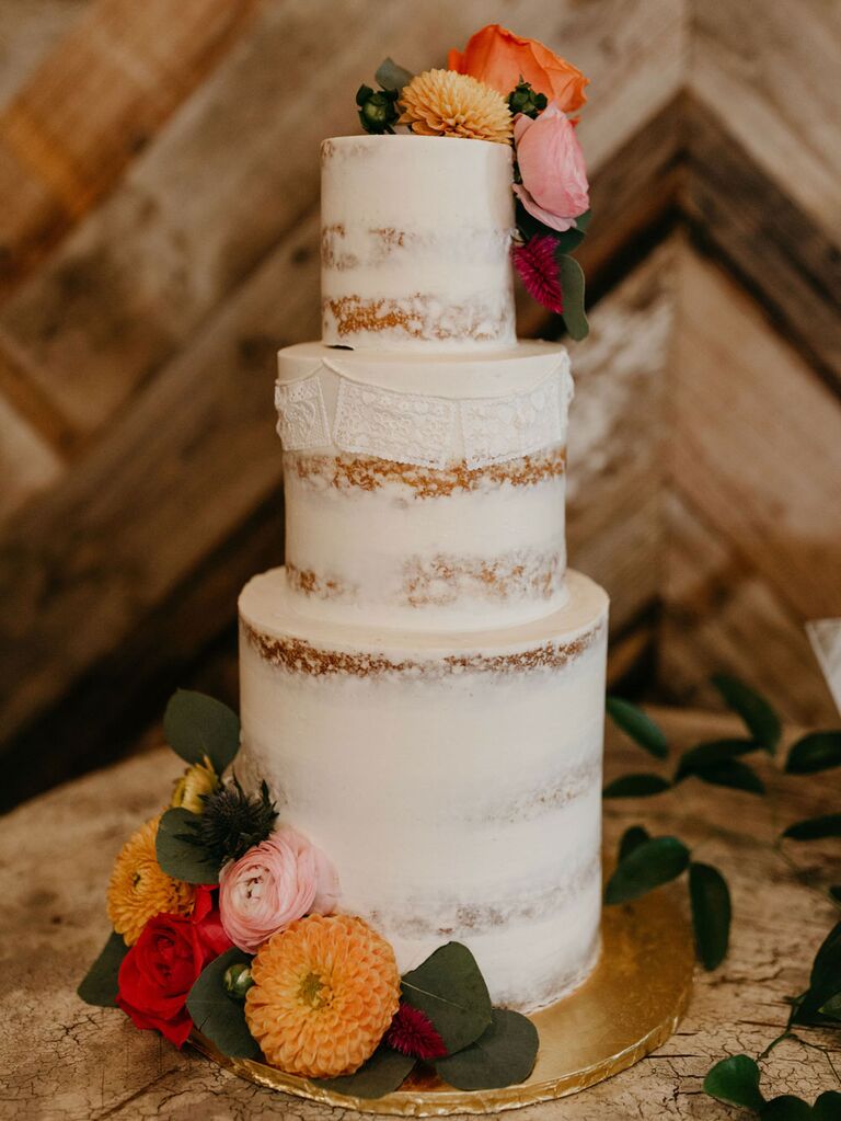 Rustic wedding cake with white semi-naked icing and mismatched tier heights