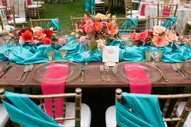 The long farm tables at the reception were decorated with turquoise runners around three teal vases filled with pink flowers. The gold mercury glass votives added plenty of romance to the space. Madeline and Joe loved the contrast between the glam details and the rustic tables, which perfectly completed the Southern aura they were going for.