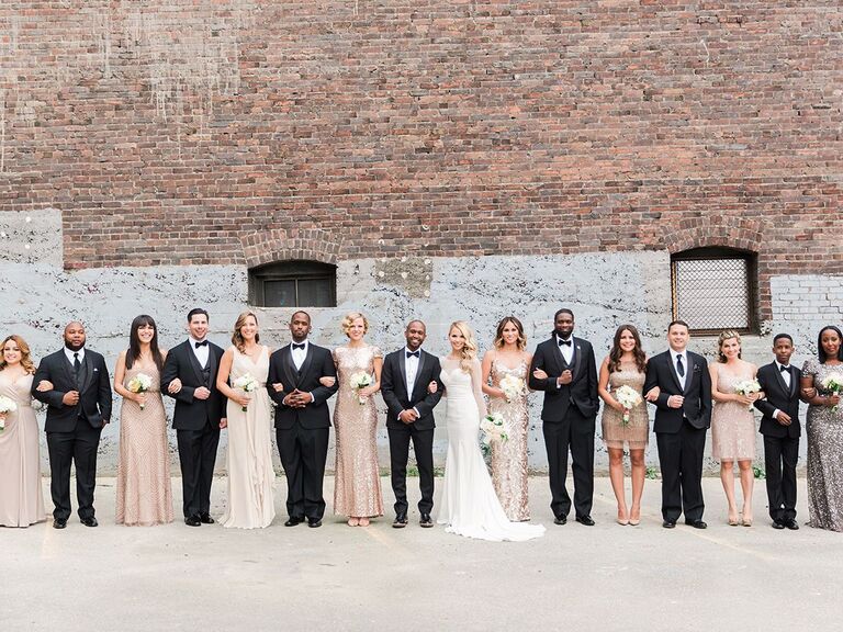 bride and groom posing with wedding party