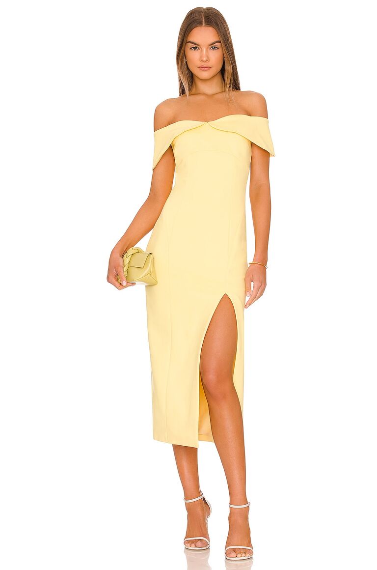 Model wears an off-the-shoulder yellow dress. 