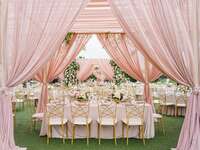 A lovely pink canopy over a wedding table setting.