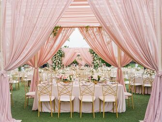 A lovely pink canopy over a wedding table setting.