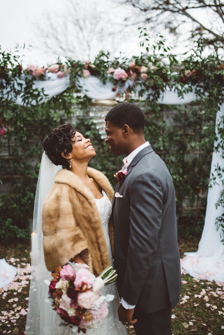 To keep warm during their postceremony photos, Morgan wore an ash blonde vintage fur cape that had belonged to her great-grandmother. Styled alongside her lace trumpet-style gown, heirloom Swarovski crystal earrings and pearl and diamond bracelet, the cozy cover-up achieved a glamorous old-Hollywood look.
