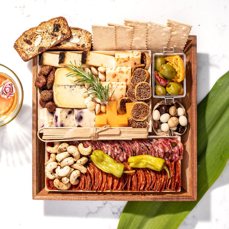 Charcuterie board featuring cheeses, crackers, and meats last-minute anniversary gift