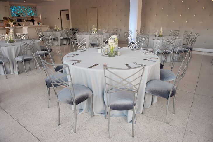 Modern silver cross-back chairs added an edgy, contemporary vibe to the classic white dining tables.