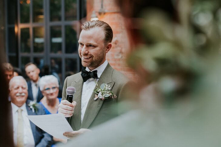 Groom in Green Suit Jacket Reading Vows During Industrial Ceremony in NYC