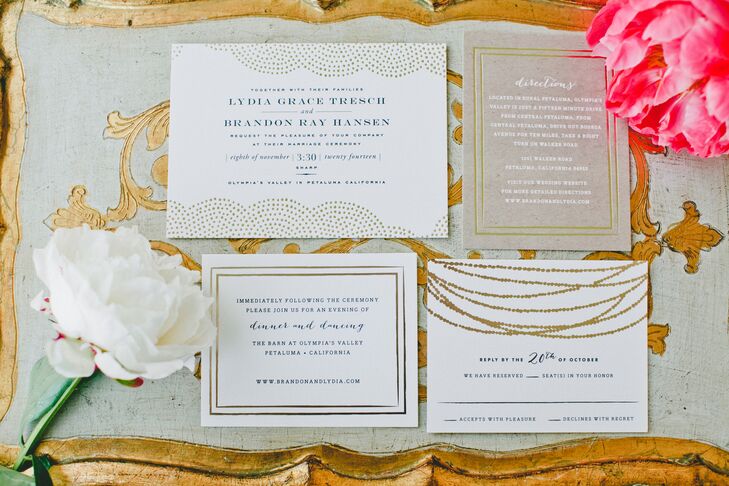 The invitations, white stationery with gold designs, gave guests a glimpse of the rustic-glam wedding to come. The directions sheet had white text printed on brown paper, which stood out from the rest of the collection.