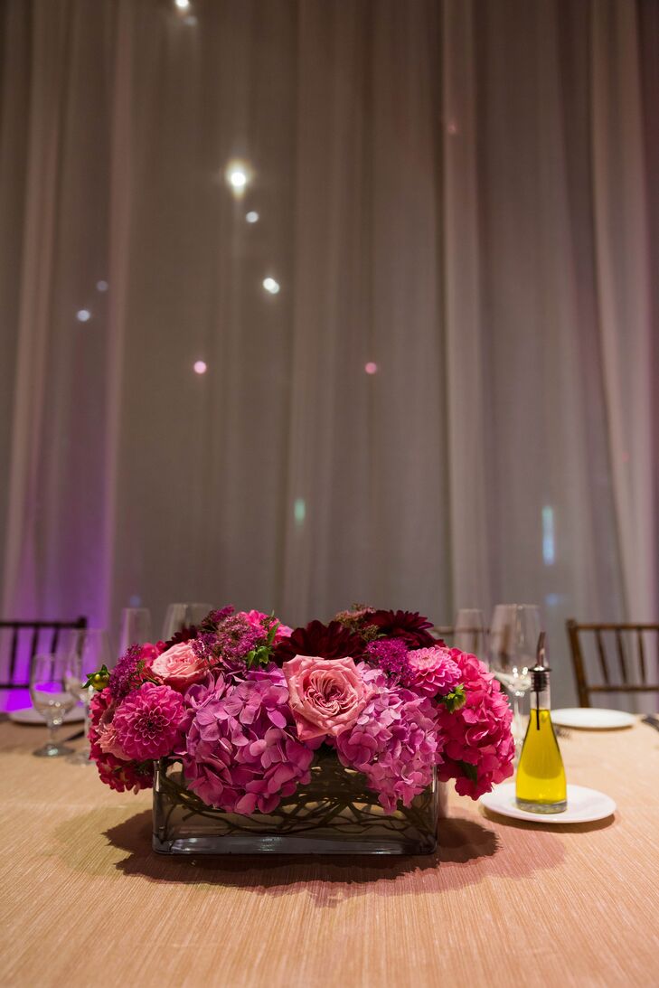A mix of pink roses, dahlias and hydrangeas decorated the reception tables.