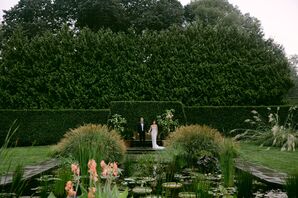 Bride and Groom in Lush Garden, Pond With Lily Pads, Grasses and Trees