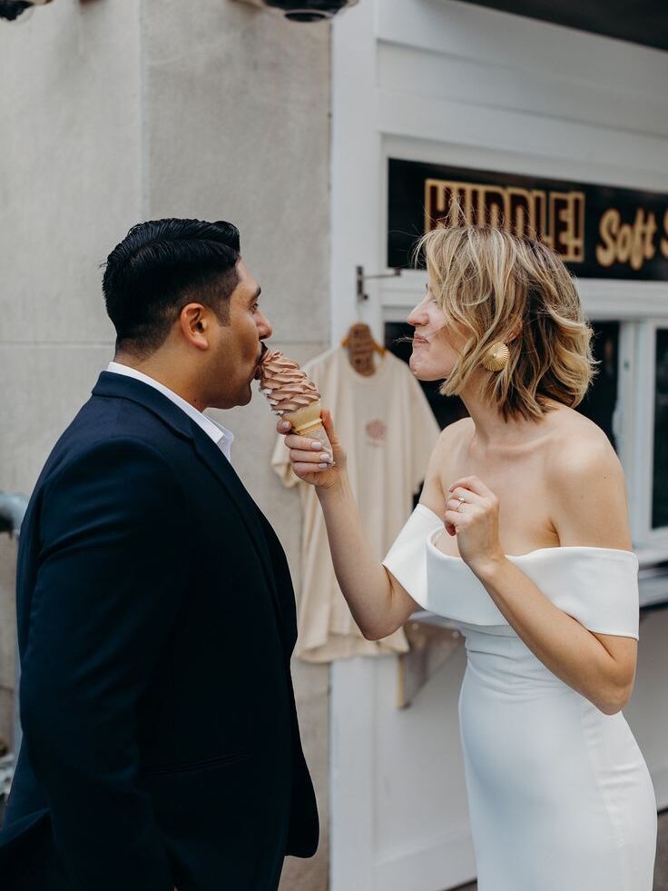 Couple sharing soft serve ice cream cone