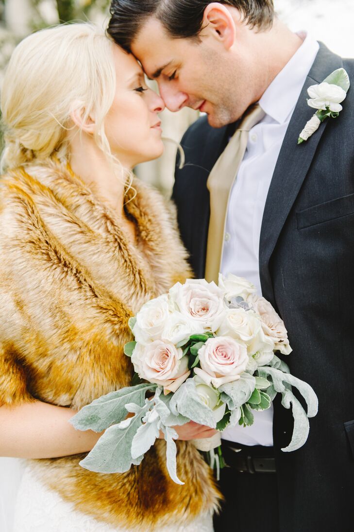 Corinne and John intimately leaned into one another in this shot. Corinne held a round bouquet filled with romantic white and light pink roses.