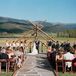Nicole and Alex's outdoor wedding ceremony was held beneath a rustic timber arch at Devil's Thumb Ranch. “We went back and forth on how we wanted to decorate the ceremony site,” says Nicole. “We ultimately decided that we didn't need any decorations at all, the view of the mountains and the ranch is spectacular enough.”