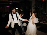 Bride and groom posing for direct flash photography at wedding reception