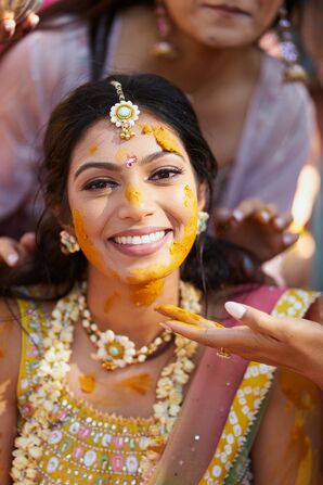 Indian Bride With Glam Makeup, Haldi Turmeric on Her Face for Traditional Ceremony