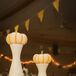 Small pumpkins were placed on top of white vases for the rustic-inspired centerpiece decor.