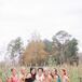 Bride Posing With Bridesmaids in Bright Dresses on Farm in Chadbourn, North Carolina