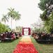 A gorgeous ombré aisle of rose petals led to the ceremony mandap (altar), which was decorated in magenta bougainvillea, jasmine and hanging strands of hot pink dendrobium orchids.
