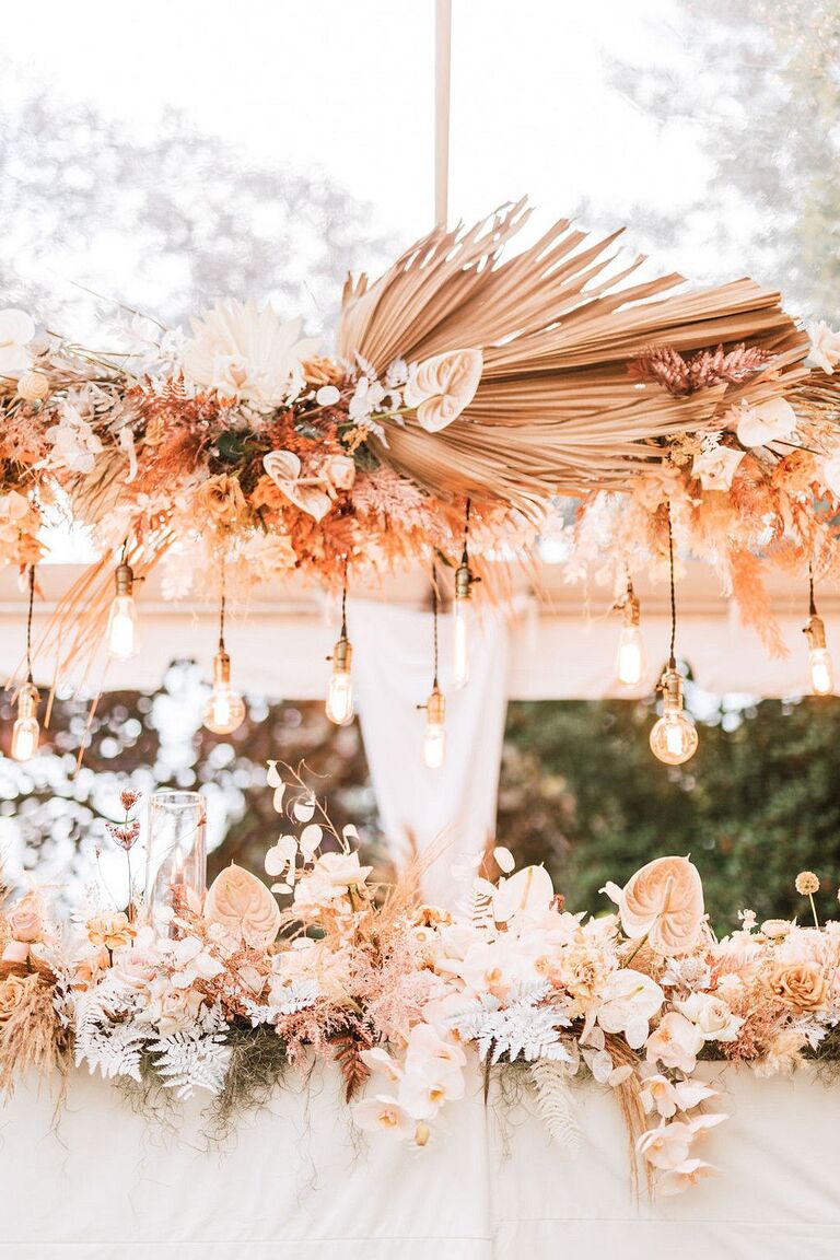 Boho chandelier with dried palm fronds and pendant lights