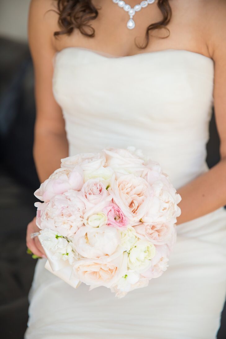 Emily carried a compact bouquet filled with her favorite flowers, including blush peonies and a fresh mix of roses. For a personal touch, the bride and her maid of honor wrapped their bouquets in matching pieces of white and gold fabric covered in rhinestones.