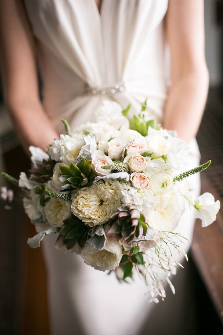 For Edith’s bouquet, Karla Cassidy Designs created a romantic arrangement of soft cream, ivory, gray, pale pink and green blooms. Garden roses, ranunculuses, sweet peas and stock flowers gave the bundle a romantic, classic feel, while veronicas, succulents and dusty miller brought an element of texture to the bouquet.