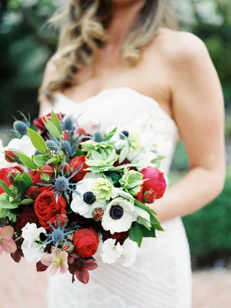 bride holds red, white and blue wedding bouquet