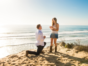 Man proposing to woman on beach