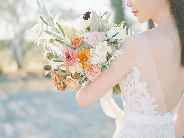 Bride holding wildflower-inspired bouquet in the desert