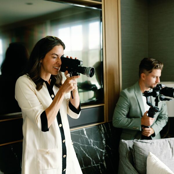 Two people holding video cameras.
