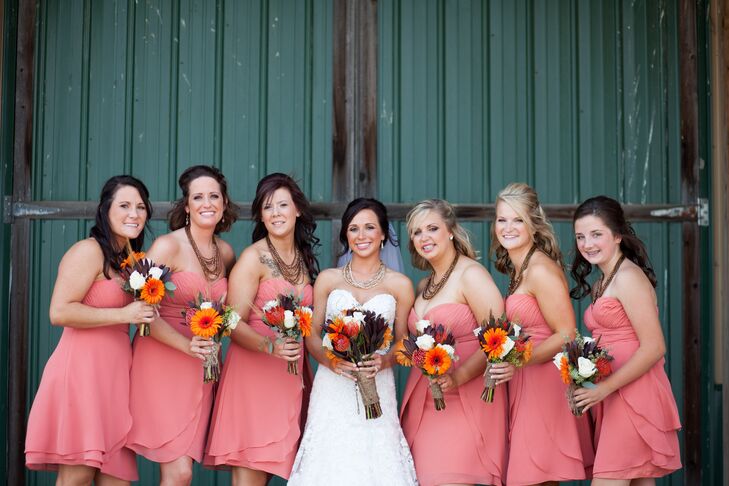 Bridesmaids wore strapless chifon gowns in coral while the bride wore a sweetheart cut Faviana gown.